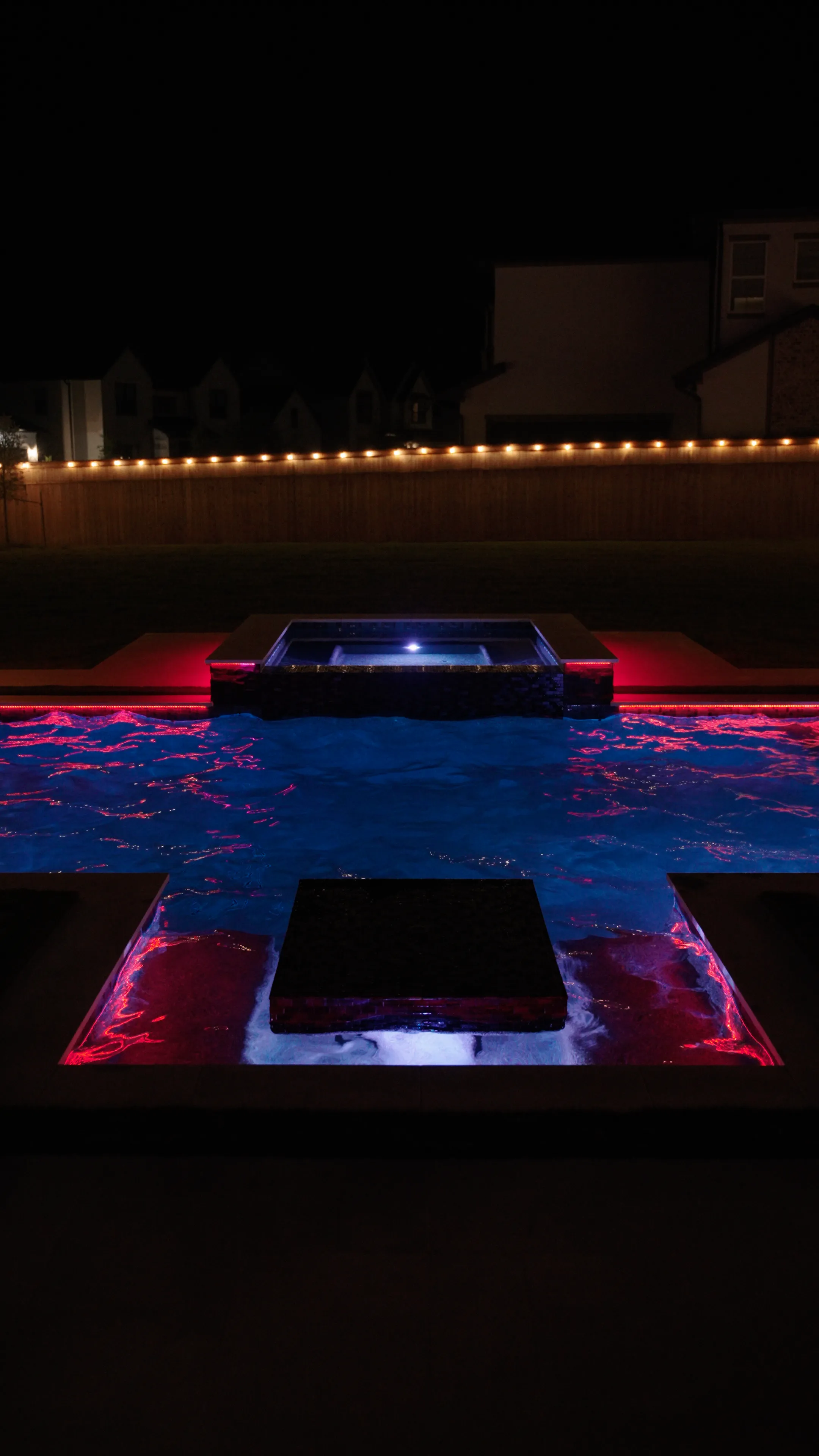Outdoor living space with fire feature and ledge loungers