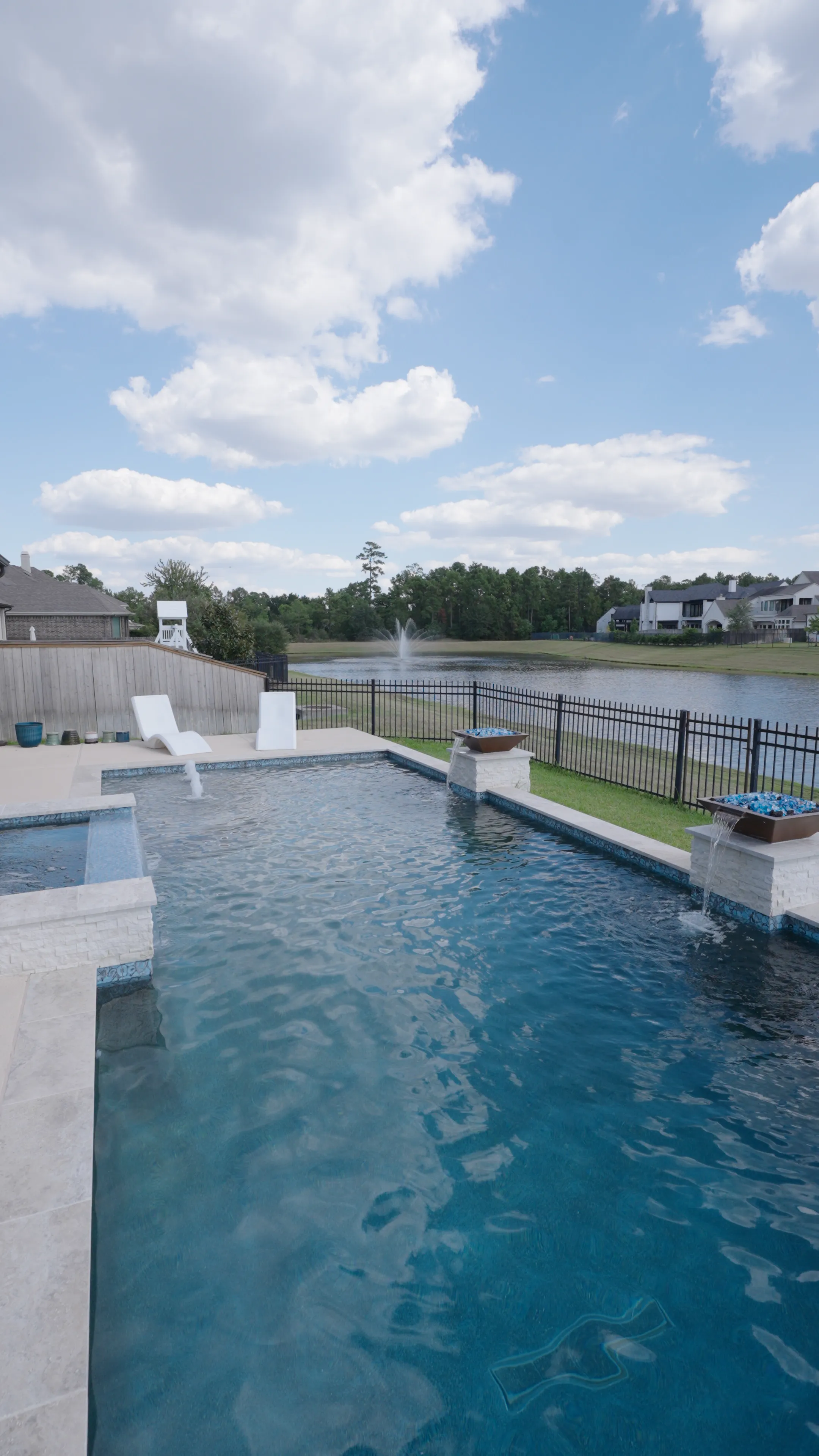 Modern luxury pool with dark interior finish and integrated spa